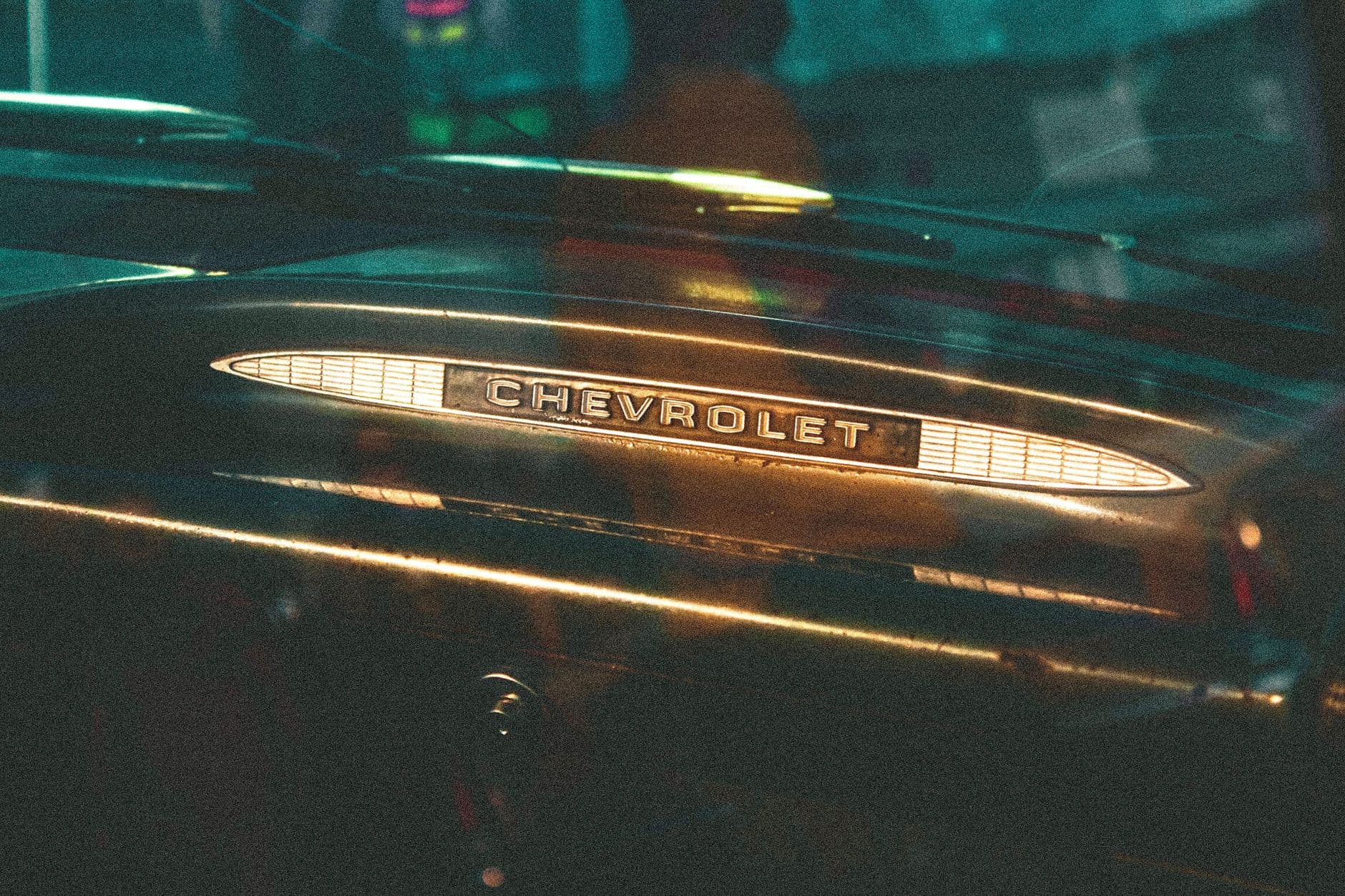 Close-up of a Chevrolet emblem on a vintage car dashboard, showcasing retro design.