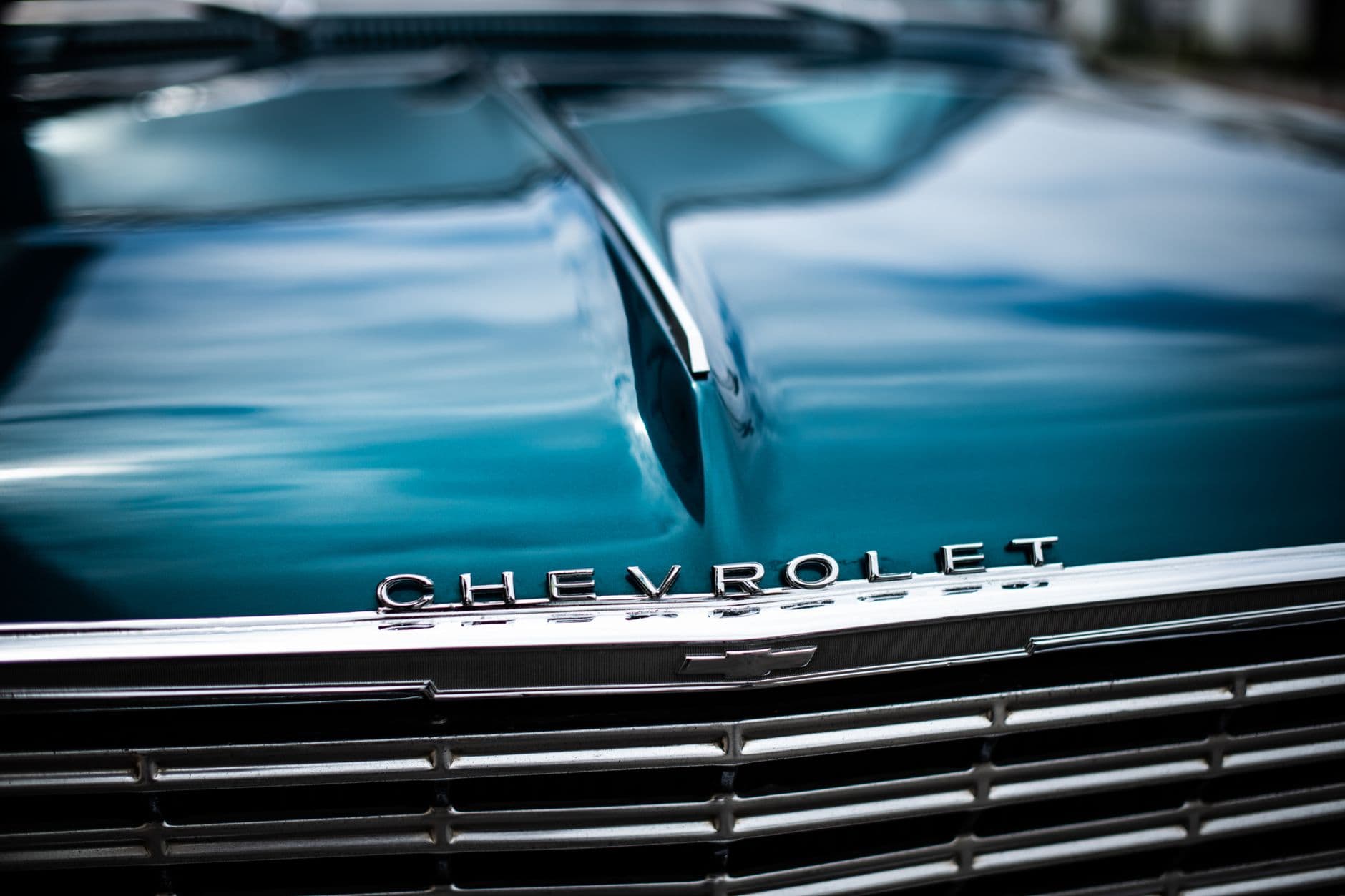 Detailed view of a vintage Chevrolet car hood with chrome detailing.
