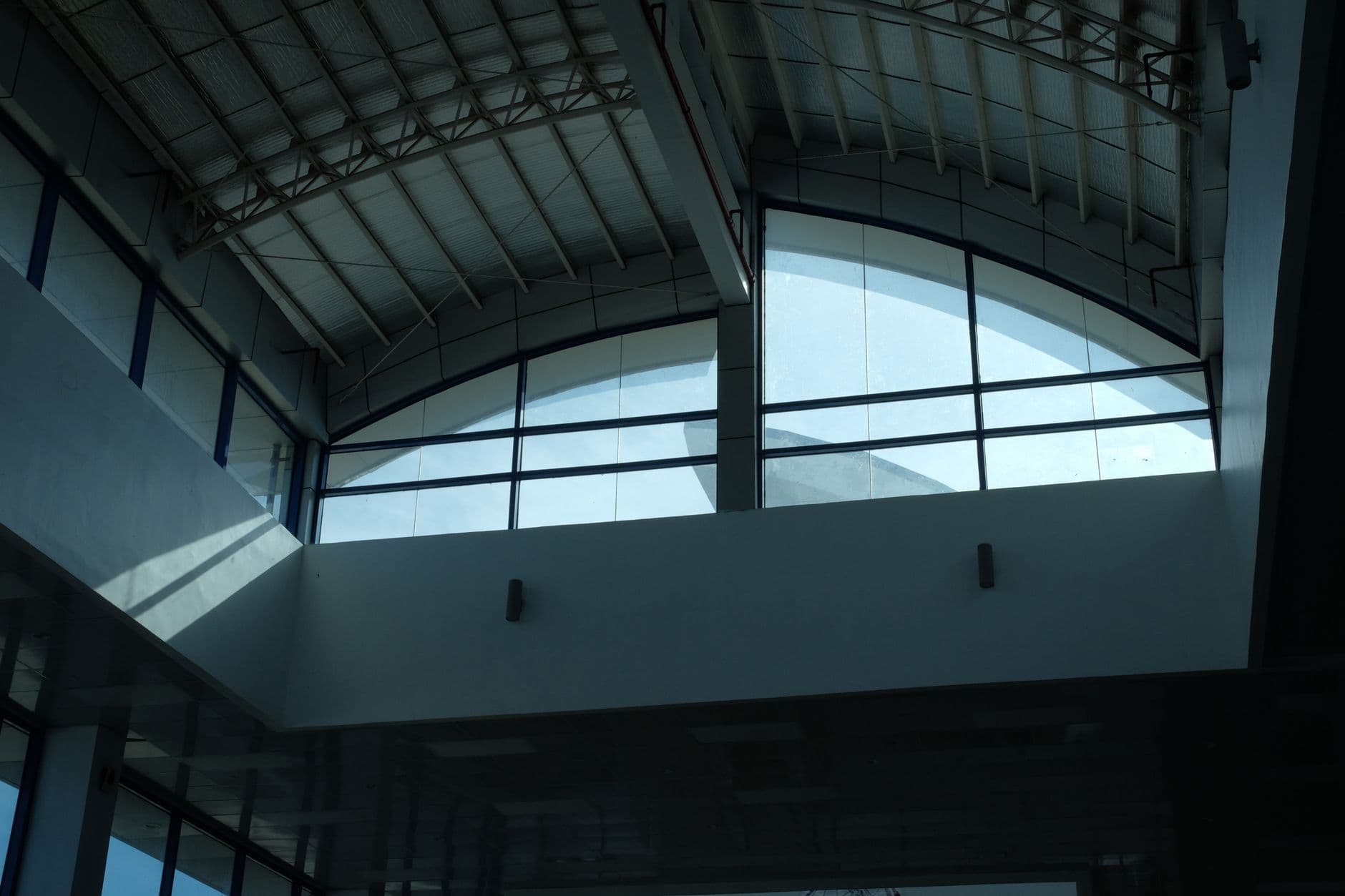 Low angle view of a modern glass ceiling in Laguindingan building, Philippines.