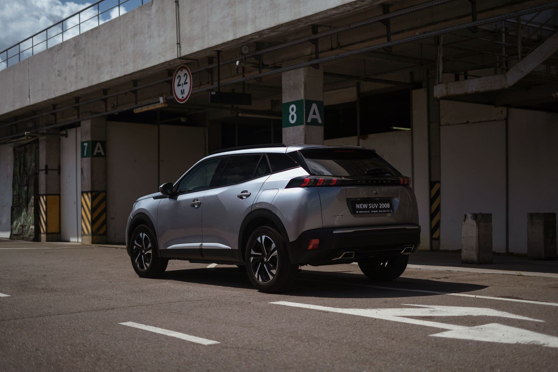 A silver SUV parked in an urban car park, showcasing modern design and structure.