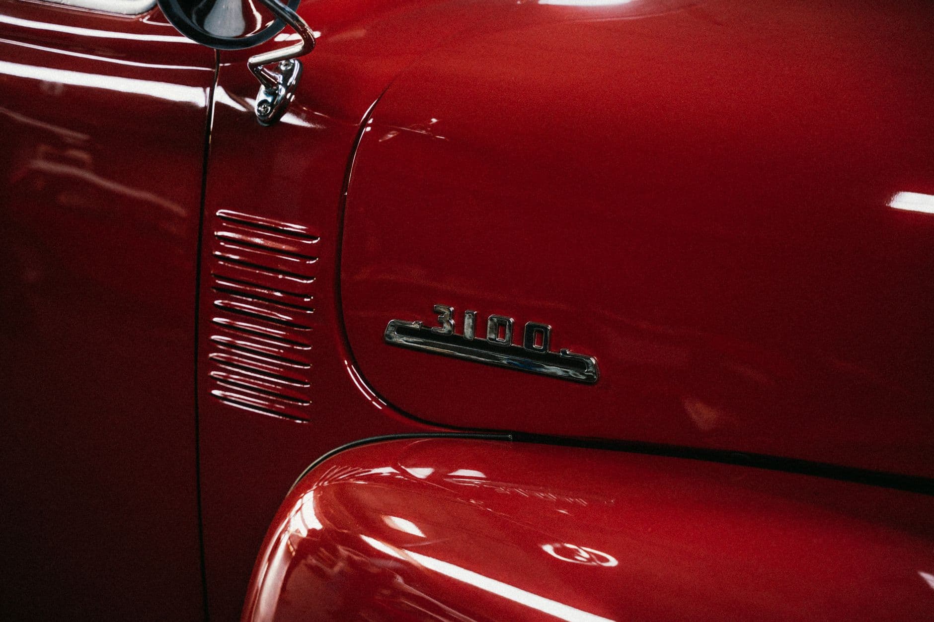 Detailed image of a classic red Chevrolet 3100 truck showcasing its shiny vintage design.