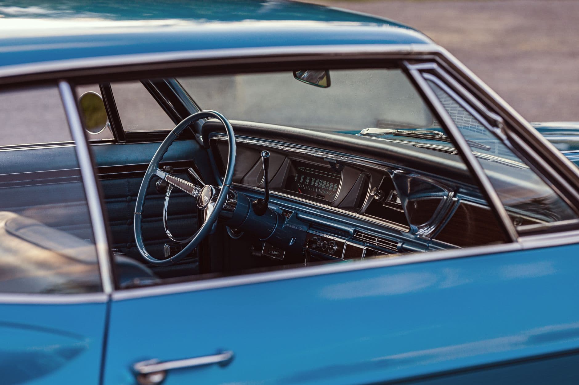 Explore the vintage interior of a 1966 Chevrolet Caprice featuring a blue exterior and classic dashboard.